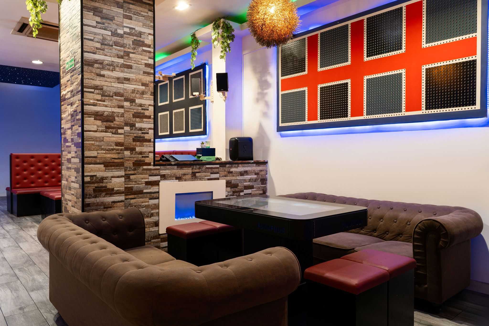 Classic lounge with brown sofas and club-style tables in the Barcelona Smoke Signals cannabis club